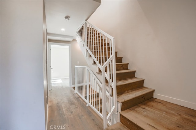 stairs with wood-type flooring