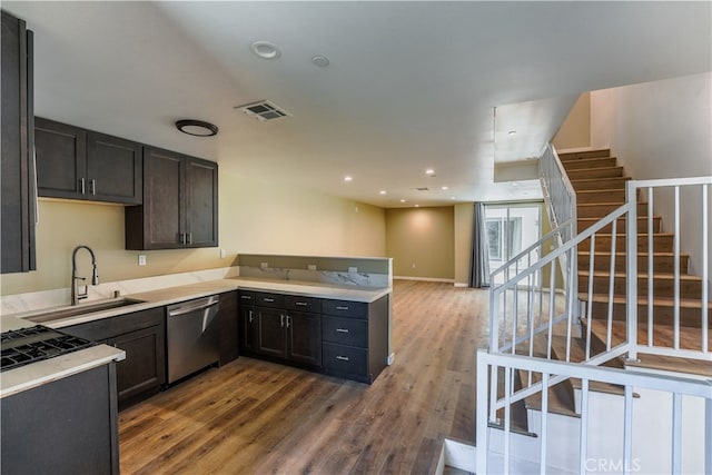 kitchen with hardwood / wood-style flooring, dark brown cabinetry, sink, and stainless steel dishwasher