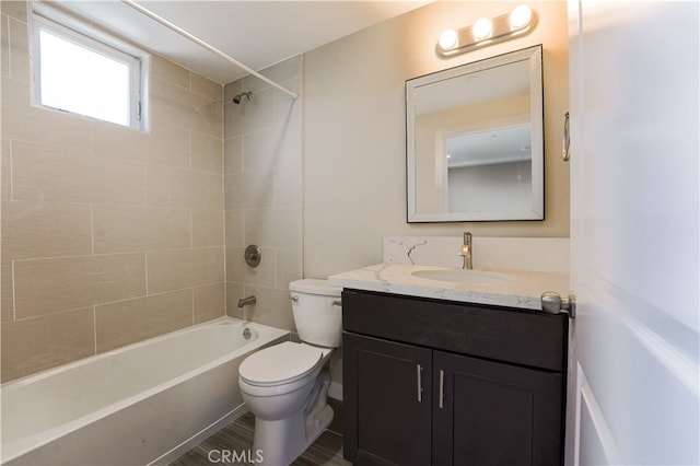 full bathroom with vanity, tiled shower / bath, and toilet