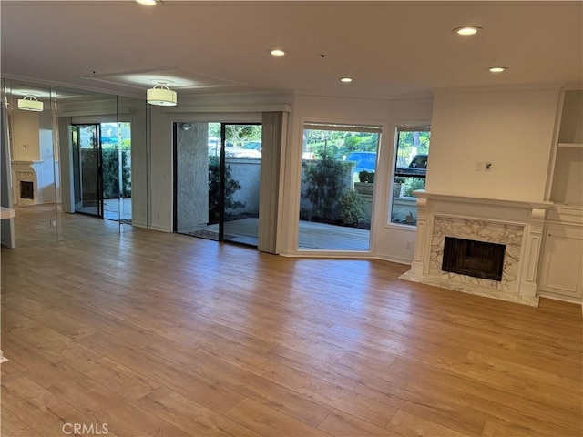 unfurnished living room featuring a fireplace and light wood-type flooring