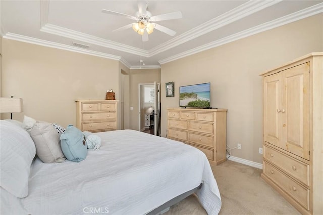 bedroom featuring a tray ceiling, light carpet, baseboards, and visible vents