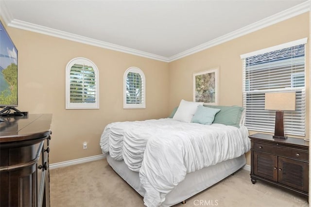 bedroom with crown molding, light colored carpet, and baseboards