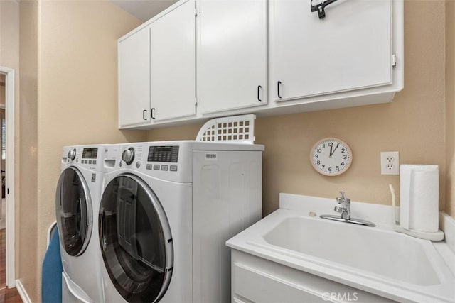 laundry room with a sink, cabinet space, and washing machine and dryer