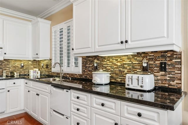 kitchen with backsplash, white cabinets, white dishwasher, and crown molding