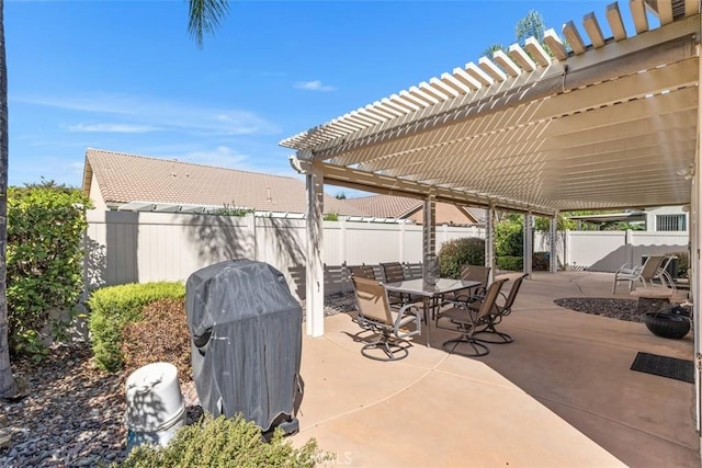 view of patio featuring area for grilling, outdoor dining space, a pergola, and a fenced backyard