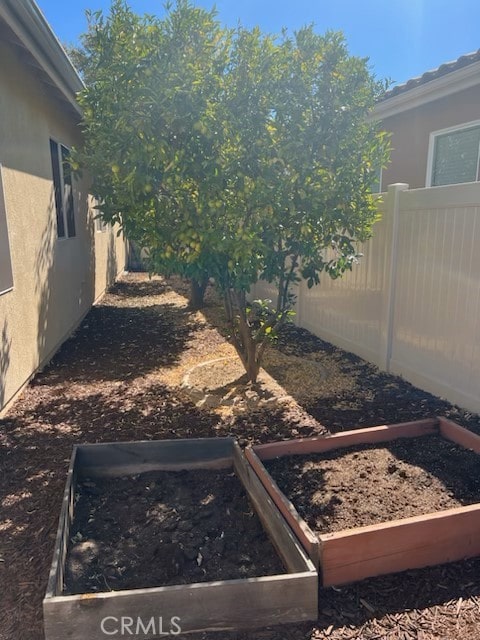 view of yard with fence and a garden