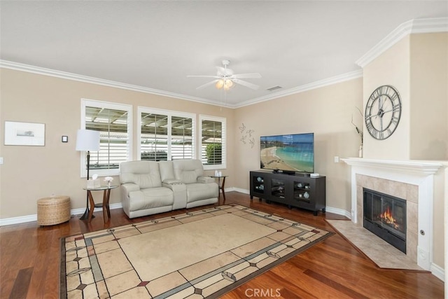 living area featuring a fireplace, wood finished floors, a ceiling fan, and visible vents