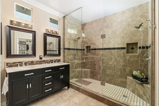 bathroom with a sink, a stall shower, double vanity, and ornamental molding