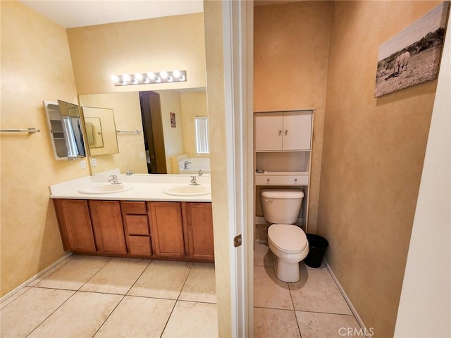 bathroom with vanity, tile patterned floors, and toilet