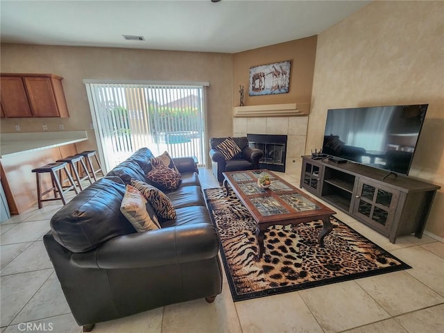 tiled living room featuring a tile fireplace