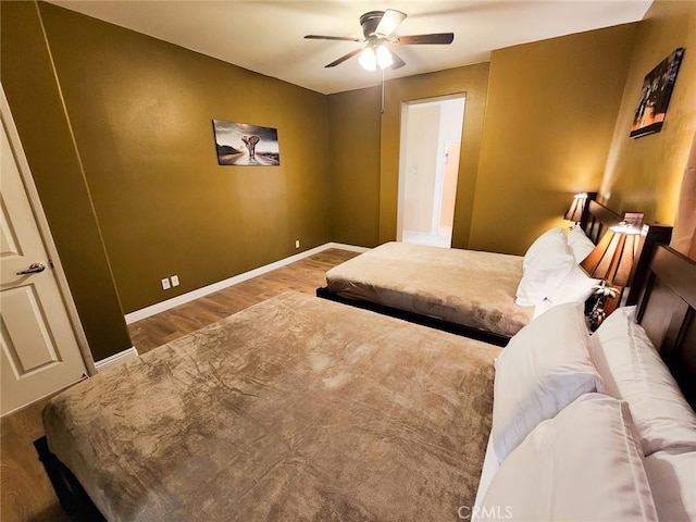 bedroom with hardwood / wood-style flooring and ceiling fan