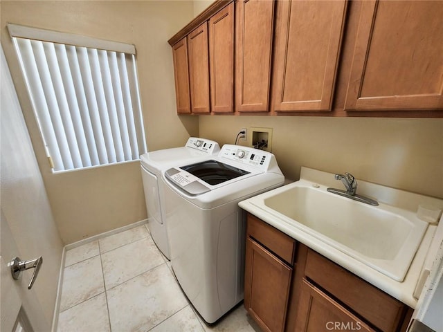 clothes washing area featuring cabinets, independent washer and dryer, sink, and light tile patterned floors