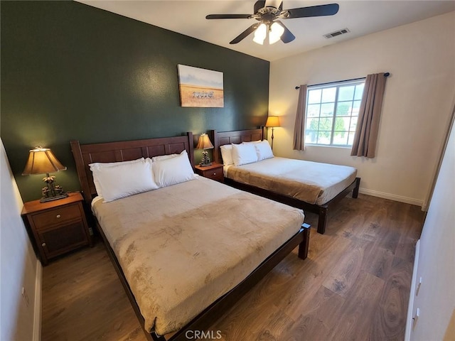 bedroom featuring dark wood-type flooring and ceiling fan