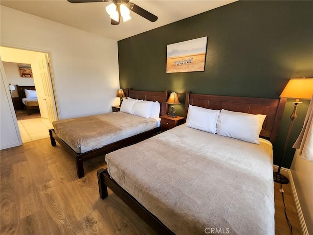 bedroom featuring ceiling fan and light hardwood / wood-style floors