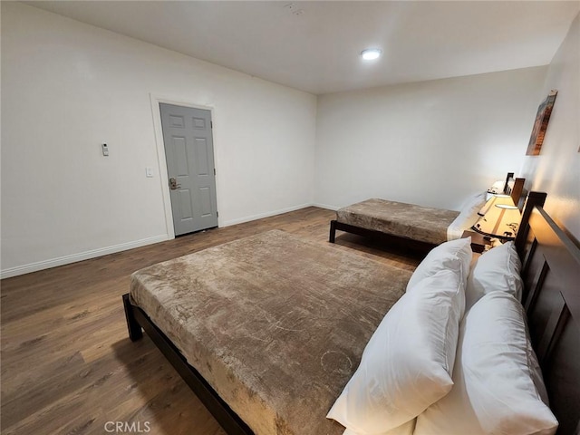 bedroom with dark wood-type flooring