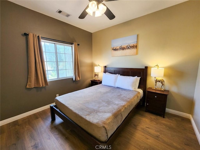 bedroom with ceiling fan and dark hardwood / wood-style flooring