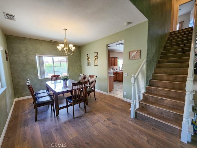 dining room with a notable chandelier and hardwood / wood-style flooring