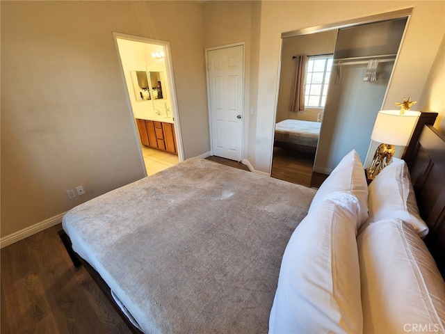 bedroom featuring ensuite bath, hardwood / wood-style floors, and a closet