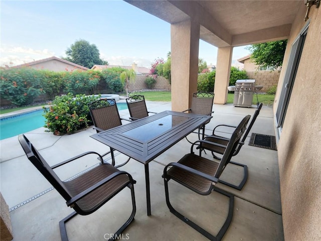 view of patio / terrace featuring a fenced in pool and area for grilling