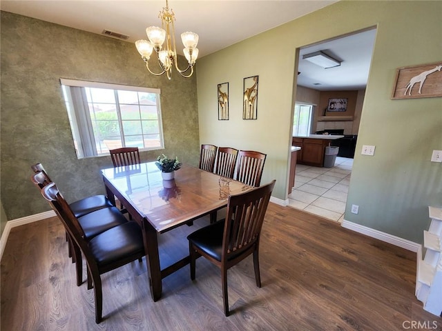 dining space featuring a chandelier and light wood-type flooring