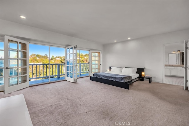 bedroom featuring french doors, carpet floors, ensuite bathroom, and access to outside