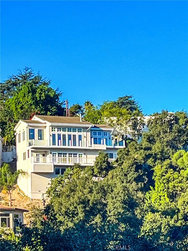 back of property with a balcony