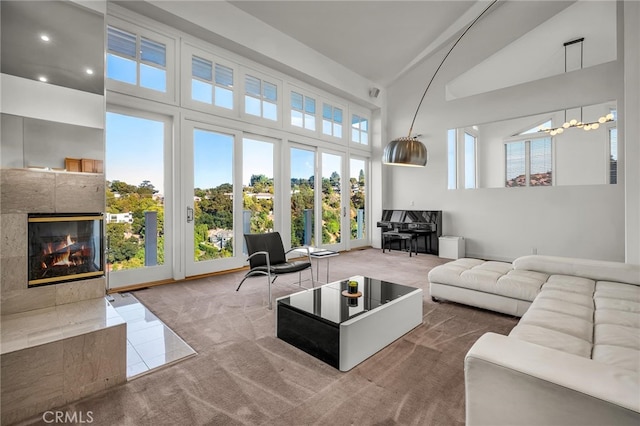 tiled living room with high vaulted ceiling and a tiled fireplace