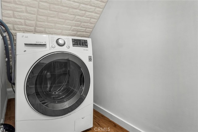 clothes washing area with washer / clothes dryer and hardwood / wood-style flooring