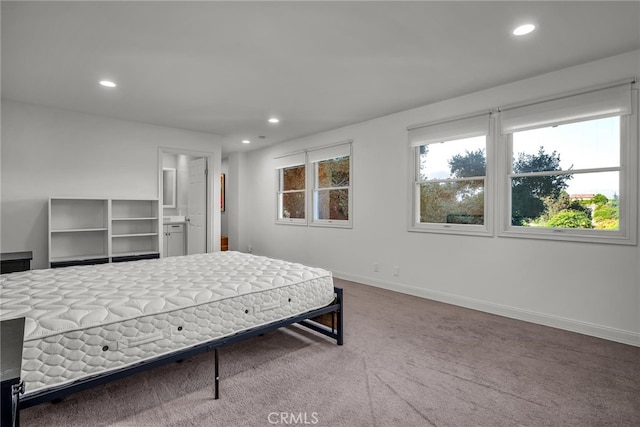 carpeted bedroom featuring ensuite bathroom