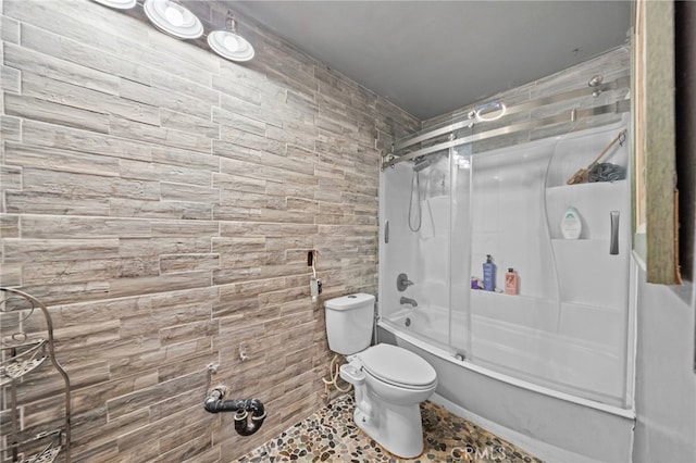 bathroom featuring toilet and enclosed tub / shower combo