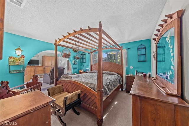 bedroom featuring carpet and a textured ceiling