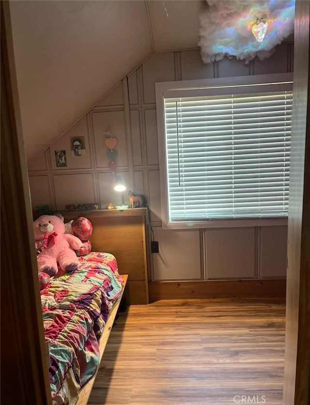 bedroom with light hardwood / wood-style flooring and lofted ceiling