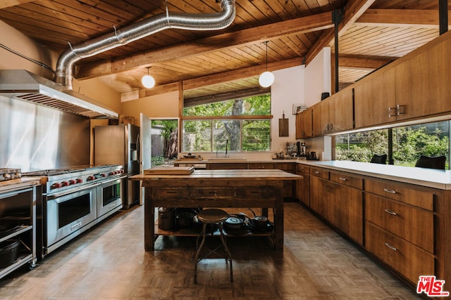 kitchen with a wealth of natural light, stainless steel appliances, wooden ceiling, vaulted ceiling with beams, and hanging light fixtures