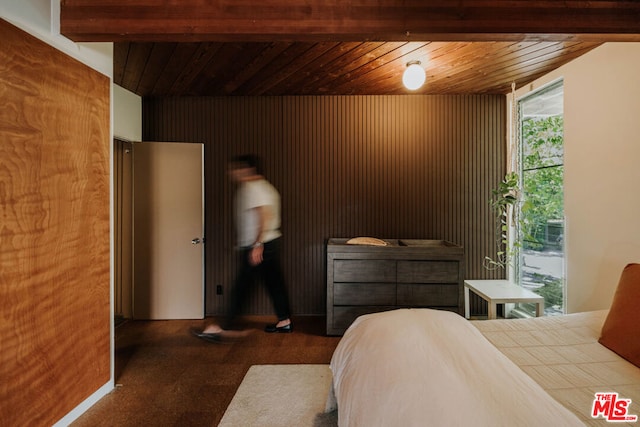 bedroom featuring carpet flooring, vaulted ceiling with beams, and wood ceiling