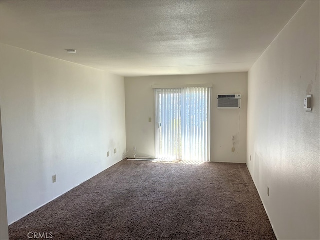 unfurnished room featuring a wall mounted air conditioner and carpet floors