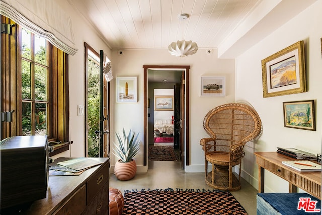 sitting room featuring crown molding and wood ceiling