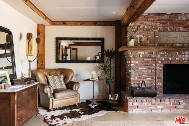 living area featuring wood ceiling and a brick fireplace