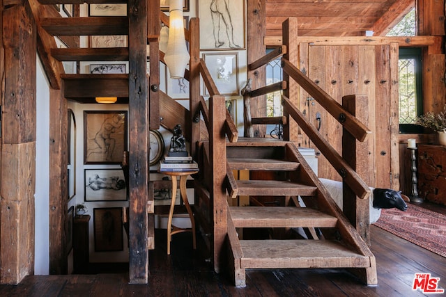 staircase with lofted ceiling and hardwood / wood-style flooring