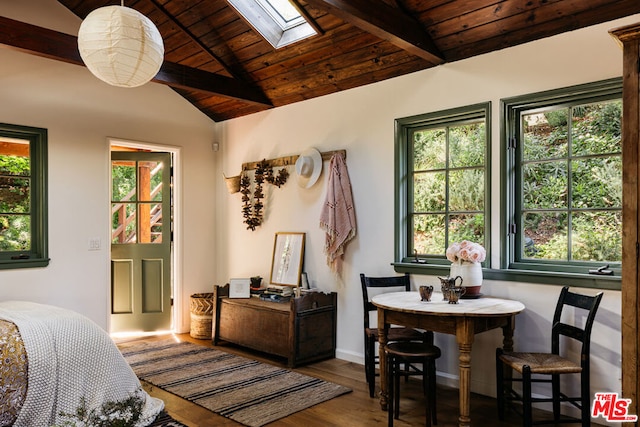 bedroom with vaulted ceiling with skylight, multiple windows, hardwood / wood-style flooring, and wood ceiling