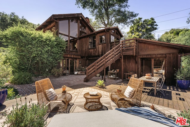 rear view of house featuring a deck