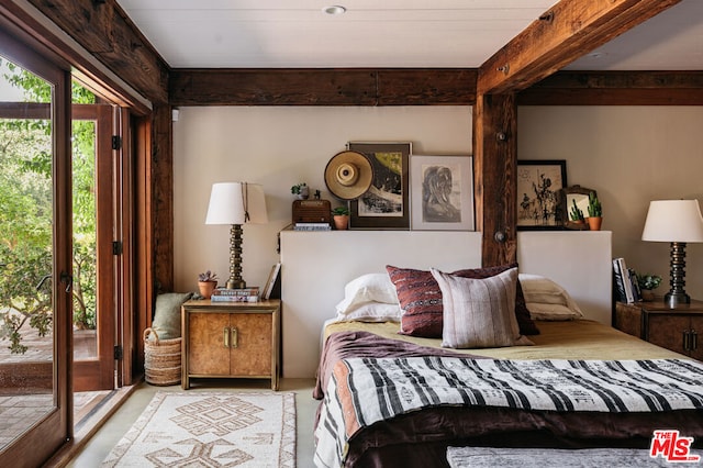 bedroom with access to outside and beamed ceiling