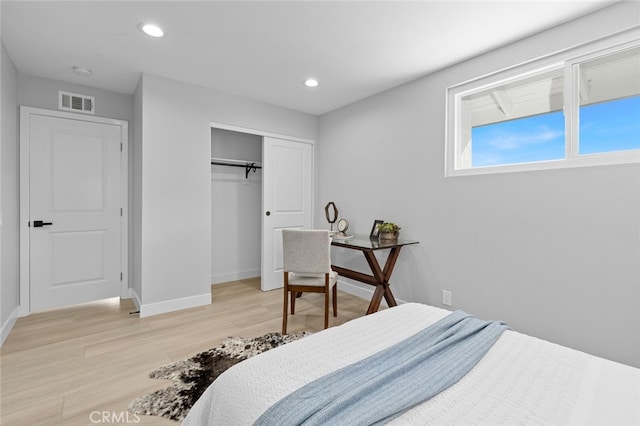 bedroom with light hardwood / wood-style flooring and a closet