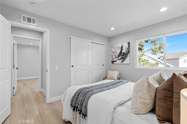 bedroom featuring a closet and light hardwood / wood-style flooring