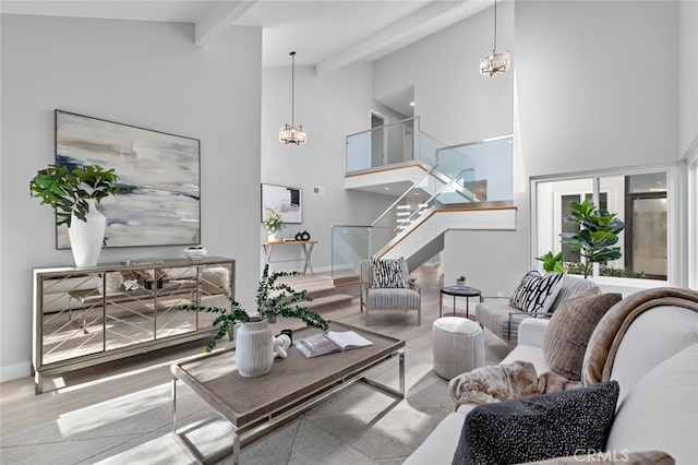 living room with beamed ceiling, hardwood / wood-style flooring, and high vaulted ceiling