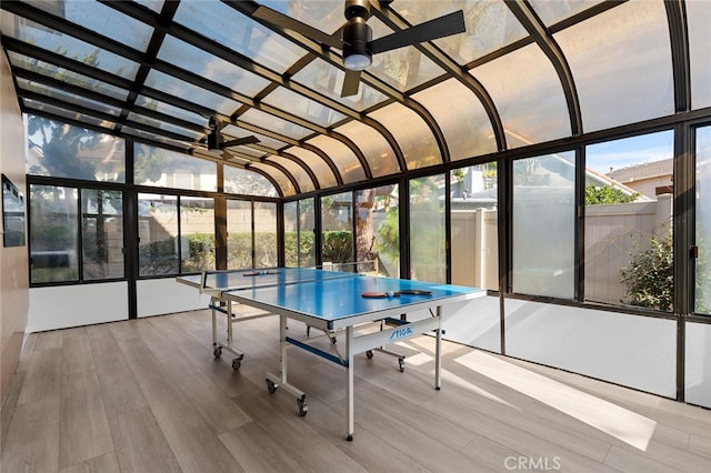 unfurnished sunroom with ceiling fan