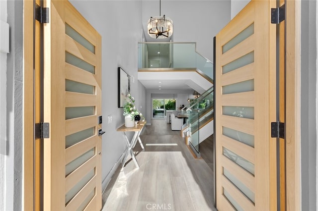 entrance foyer with an inviting chandelier and light hardwood / wood-style floors