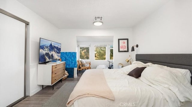 bedroom with visible vents and wood finished floors