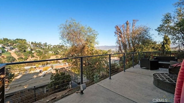 balcony with outdoor lounge area and a mountain view
