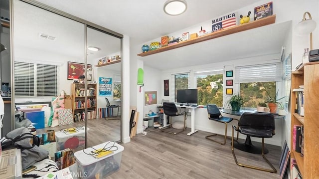 home office featuring visible vents and wood finished floors