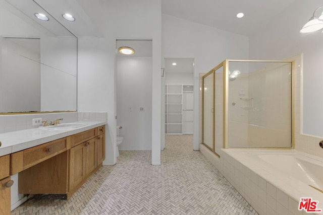 full bathroom with shower with separate bathtub, vanity, vaulted ceiling, and toilet